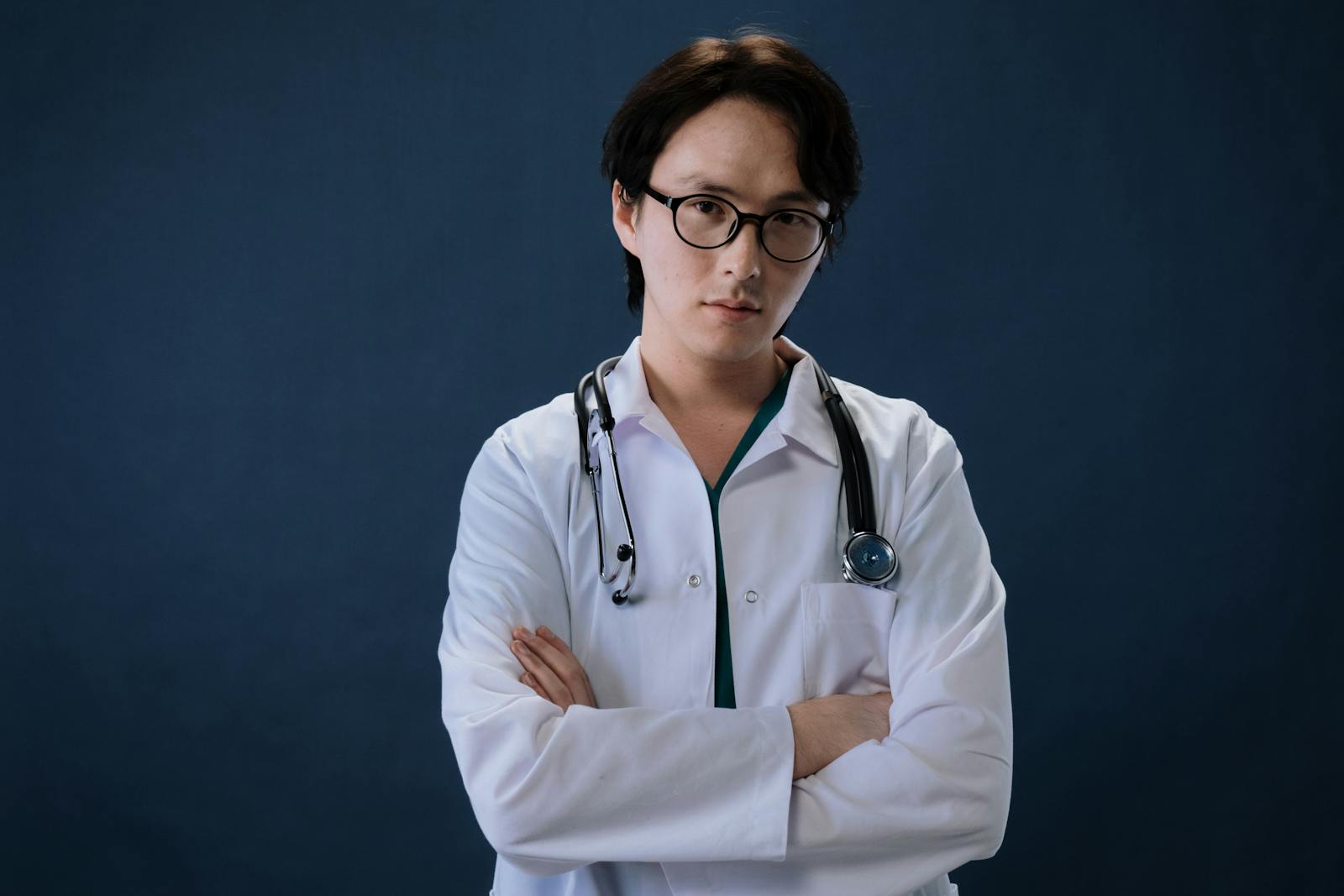 Man in White Laboratory Gown Wearing Black Framed Eyeglasses